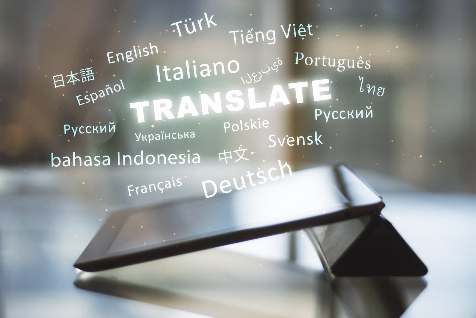 Tablet displaying 'Translate' surrounded by language names in many scripts