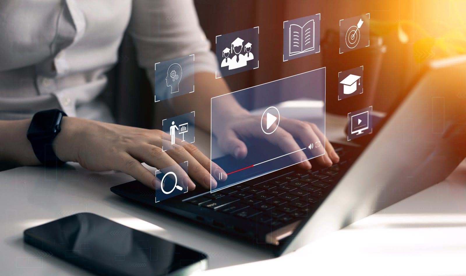 Hands on a laptop with floating learning-platform app icons connected around a video lesson